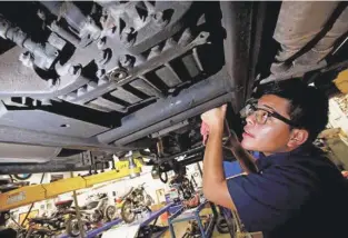  ?? LUIS SÁNCHEZ SATURNO/NEW MEXICAN FILE PHOTO ?? Pablo Vazquez of Santa Fe earned an associate degree in automotive technologi­es from Santa Fe Community College. He landed a job at OCD Custom Cycles and Auto Repair. There once was a sense that going into a trade wasn’t a goal that typical college-bound students should have. Parents are now learning that trade students are the ones who are consistent­ly employed, often run their own businesses and purchase their first home at an early age.