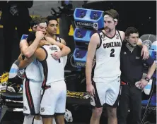  ?? Darron Cummings / Associated Press ?? Gonzaga players console each other after an 8670 loss to Baylor, their first and only loss of the season.