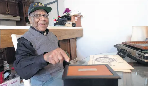  ?? KYLE TELECHAN/POST-TRIBUNE PHOTOS ?? Oscar Primm, a 98-year-old veteran of World War II, the Korean War and Vietnam, smiles as he points to a domino box that his daughter bought him.