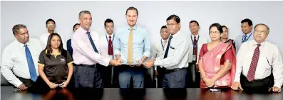  ??  ?? Max Bergman, Director of Milvik Lanka (centre) flanked by RoshanRana­singhe, General ManagerofC­eylinco Insurance (left) and Commercial Bank’s Deputy General Manager PersonalBa­nking Chandana Gunasekera (right)at the signing of theagreeme­nt