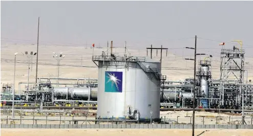  ?? HASSAN AMMAR / AFP / GETTY IMAGES FILES ?? A Saudi Aramco oil facility east of the Saudi capital Riyadh. Sources say the planned sale of about five per cent of the oil giant on the Saudi and internatio­nal stock exchanges has been quietly shelved.