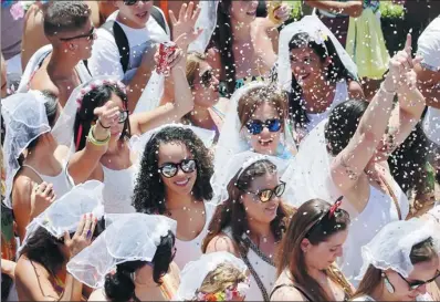  ?? PAULO WHITAKER/ REUTERS ?? Revellers dance as they take part in the annual “Marry me” carnival block parade in the main street in Sao Paulo, Brazil, on Saturday.