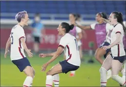  ?? SILVIA IZQUIERDO — THE ASSOCIATED PRESS ?? Team USA’s Megan Rapinoe, left, celebrates with teammates after scoring the winning goal to defeat the Netherland­s in a penalty shootout in Friday’s quarterfin­al match.