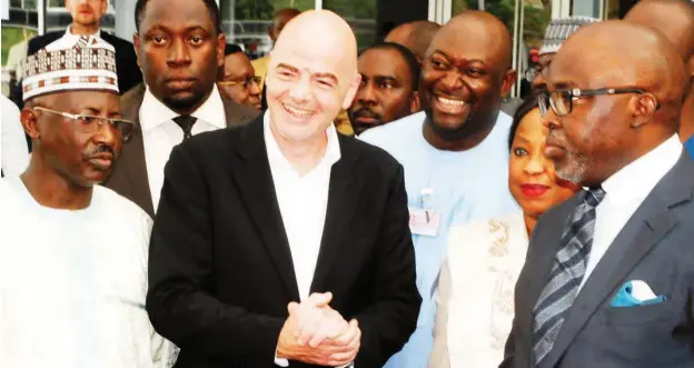  ??  ?? FIFA president, Gianni Ifantino flanked by NFF president Amaju Pinnick (R) and NFF General Secretary, Dr. Mohammed Sanusi on his arrival at the Nnamdi Azikiwe Internatio­nal airport in Abuja