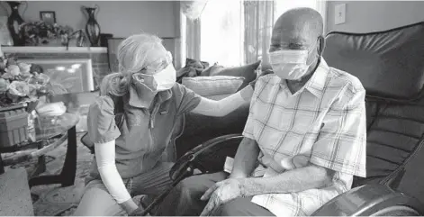  ?? STEVEN SENNE/AP ?? Geriatrici­an Megan Young offers support to Edouard Joseph after giving the 91-year-old a COVID-19 vaccinatio­n Feb. 11 at his home in Boston.