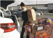  ?? Ben Margot / Associated Press 2020 ?? Instacart gig worker Saori Okawa prepares a delivery at a grocery store last year in San Leandro.