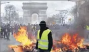  ?? AP ?? A protester stands in front of a barricade on fire during a yellow vests demonstrat­ion in Paris.