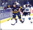  ?? DAVID CROMPTON/The Okanagan Weekend ?? Vernon Vipers defenceman Michael Young, left, battles with Penticton Vees forward Ryan Sandelin during BCHL action Friday.