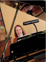  ?? Arkansas Democrat-Gazette/JOHN SYKES JR. ?? Arkansas Symphony Orchestra supporter Camille Williams plays a living-room concert. Williams is co-chairman, with Nancy Cole, of the symphony guild’s playing card fundraiser.