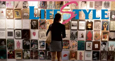  ??  ?? ONLOOKER ponders a wall of paintings at Art Fair Philippine­s.