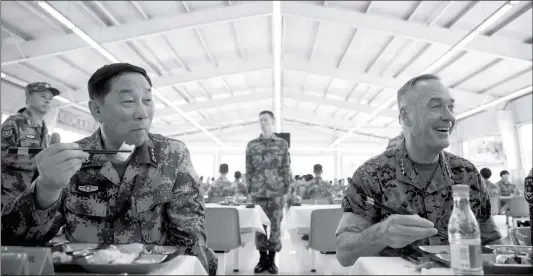  ??  ?? Chinese Northern Theater Command Commander Song Puxuan and chairman of the US Joint Chiefs of Staff Joseph Dunford eat lunch at the Northern Theater Command Army Force Haicheng Camp in Haicheng, Liaoning Province, Wednesday.