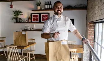  ?? JACQUELYN MARTIN — THE ASSOCIATED PRESS ?? Matt Baker, chef and owner of Gravitas, inside the restaurant in Washington on Feb. 14. Gravitas has a subscripti­on service offering a monthly meal for two.