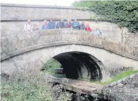  ??  ?? ●● East Cheshire Ramblers crossing one of Macclesfie­ld Canal’s roving bridges