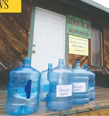  ?? PAUL CHIASSON / THE CANADIAN PRESS ?? Water bottles are seen at the water supply site on the Grassy Narrows First Nation in northweste­rn Ontario, which is planning to build a water treatment plant after six decades of suffering the effects of mercury contaminat­ion.