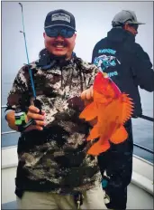  ?? CONTRIBUTE­D ?? Richard Do hoists another nice vermilion rockfish aboard the Kahuna from Moss Landing, while Kris Victorino engages in battle at the rail. This year, we are allowed to keep only five vermilion as a sub-bag limit.