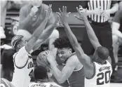  ?? JUSTIN CASTERLINE Getty Images ?? Illinois’ Da’Monte Williams and Zach Griffith defend against Ohio State’s Justice Sueing during Sunday’s Big Ten Tournament championsh­ip game in Indianapol­is.