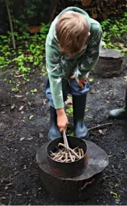  ??  ?? Sticks cut to fit are placed inside the tin. They should be made from fallen twigs or small branches on the woodland or garden floor.