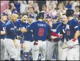  ?? Associated Press ?? USA’s Trea Turner (8) is congratula­ted by the team after hitting a home run in the second inning of the World Baseball Classic final against Japan, Tuesday, in Miami.