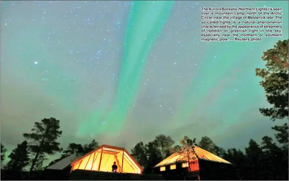  ??  ?? The Aurora Borealis (Northern Lights) is seen over a mountain camp north of the Arctic Circle, near the village of Mestervik late. The so-called lights is a natural phenomenon characteri­sed by the appearance of streamers of reddish or greenish light in the sky, especially near the northern or southern magnetic pole. — Reuters photo