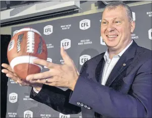  ?? CP PHOTO ?? CFL commission­er Randy Ambrosie tosses a football during a press conference in Toronto on July 5, 2017.