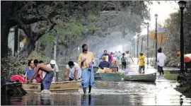  ?? AMERICAN-STATESMAN ?? New Orleans residents driven out of their homes by Hurricane Katrina gather in the city’s Gardens District waiting to be evacuated to safety on Sept. 1, 2005.