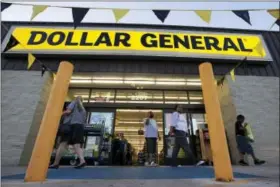  ?? AP FILE PHOTO ?? In this Wednesday, Sept. 25, 2013, file photo, customers exit a Dollar General store in San Antonio.