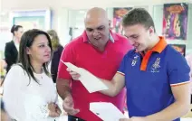  ?? Pawan Singh / The National ?? Omar Moussa rejoices at his results with his parents, Nermin Moussa, left, and Hazem Moussa, at the Gems Wellington Internatio­nal School in Dubai, which boasted high scores overall.