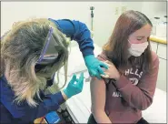  ?? THE ASSOCIATED PRESS ?? Clinical research coordinato­r Tammy Lewis-McCauley administer­s an injection to Katelyn Evans as part of the hospital’s clinical trial of Pfizer’s COVID-19 vaccine at Cincinnati Children’s Hospital Medical Center.