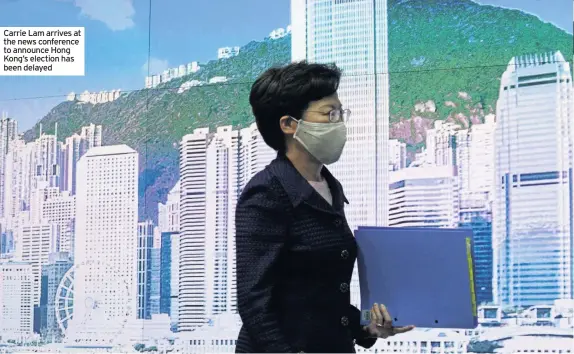  ??  ?? Carrie Lam arrives at the news conference to announce Hong Kong’s election has been delayed