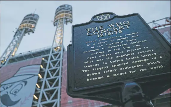  ?? (AP/John Minchillo) ?? A memorial plaque for the 11 concertgoe­rs killed in a crush of people entering a 1979 concert by the British rock band The Who outside Great American Ball Park in Cincinnati. Alumni of nearby Finneytown High School, who lost three classmates in the tragedy, faced obstacles in 2020 to their annual memorial scholarshi­p fundraisin­g event.