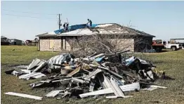  ?? WILLIAM WIDMER/THE NEW YORK TIMES ?? Austin Pearce, center, works with his uncles to replace a tarp over the weekend in Iowa, Louisiana. The tarp was initially installed on his roof after Hurricane Laura hit Aug. 27.