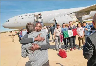  ?? Spanish Defence Ministry/Associated Press ?? In this photo provided by the Spanish Defence Ministry, passengers from Sudan disembark from a Spanish Air Force aircraft Monday at Torrejon Air Base in Madrid.