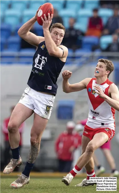  ??  ?? Launceston’s Jobi Harper marks in front of Clarence’s Oscar Paprotny at Blundstone Arena. Picture: Chris Kidd