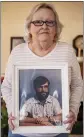  ?? SERGIO FLORES THE NEW YORK TIMES ?? Donna Boatright holds a photograph of her late husband Benny in her home in Abilene, Texas, earlier this month.