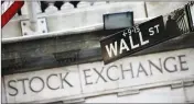  ?? ASSOCIATED PRESS ?? THIS 2013 FILE PHOTO shows a Wall Street street sign outside the New York Stock Exchange.