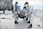  ?? ROYAL MALAYSIAN NAVY ?? Malaysian sailors carry an unidentifi­ed body to the deck of their frigate after it was found in waters off Malaysia.