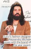  ??  ?? Gucci’s fashion designer Alessandro Michele poses with the brand of the year award.