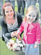  ?? ?? In 2012: Donna McCrimmon was presented with a basket of flowers from Fallon Dunlop at the opening of Argyll Bowling Club’s green for the new season on Saturday. Donna, the daughter of President Donny McCrimmon, had the honour of throwing the first jack.