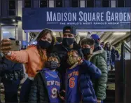  ?? BRITTAINY NEWMAN - THE ASSOCIATED PRESS ?? The Quershif family take a selfie outside Madison Square Garden before an NBA basketball game between the New York Knicks and the Golden State Warriors in New York on Tuesday, Feb. 23, 2021. A limited number of fans was allowed to attend.