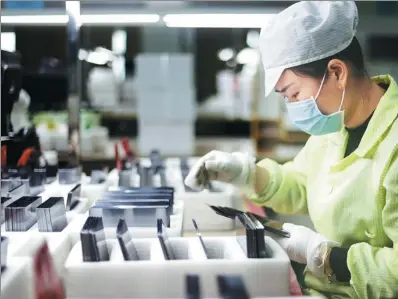  ?? ZHANG HAIYAN / FOR CHINA DAILY ?? A technician works on photovolta­ic products at a high-tech company in Jiujiang, Jiangxi province.