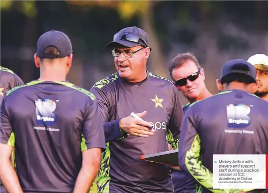  ?? Virendra Saklani/Gulf News ?? Mickey Arthur with players and support staff during a practice session at ICC Academy in Dubai.