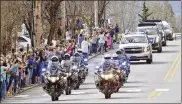  ?? JOHN D. SIMMONS / THE CHARLOTTE OBSERVER ?? Mourners line Highway 70 through Black Mountain, N.C., as the motorcade carrying the Rev. Billy Graham passes by Saturday. It was a chance for residents in some of Graham’s favorite places to pay tribute.