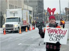  ?? ALLAN BENNER/STANDARD STAFF ?? Niagara College student Pawel Szopinski greets people as they arrive at the Great Holiday Food Drive to help clients of Community Care of St. Catharines and Thorold last Friday.