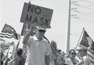  ??  ?? Protesters rally against a mask mandate, many showing support for President Donald Trump, in Las Vegas on Saturday.