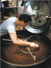  ?? Mark Costantini / The Chronicle 2009 ?? Jeremy Tooker inspects a batch of roasting coffee at Four Barrel Coffee in 2009. A sexual harassment lawsuit in January forced his divestment of the company he founded and spurred a promise from the two remaining owners to make the specialty roaster employeeow­ned.