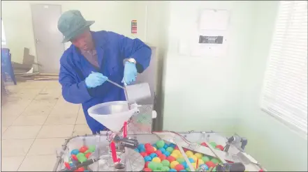  ?? Photo: Nust ?? Renewable energy… Mechanical engineerin­g intern at Nust, Elago Ileka, feeding the biogas pilot plant with chicken manure. Once fully installed the plant intends to convert 40 tons of chicken waste per day into biogas.