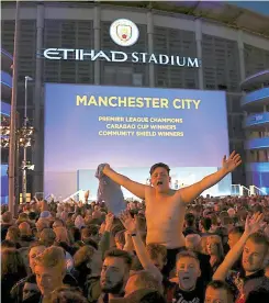  ?? PA ?? Over the moon: City fans celebrate at the Etihad