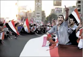  ?? HASSAN AMMAR/ASSOCIATED PRESS ?? Opponents of Egypt’s President Mohammed Morsi protest outside the presidenti­al palace in Cairo on Monday. Egypt’s military on Monday issued an ultimatum to the Islamist president and his opponents to reach an agreement to “meet the people’s demands” or...