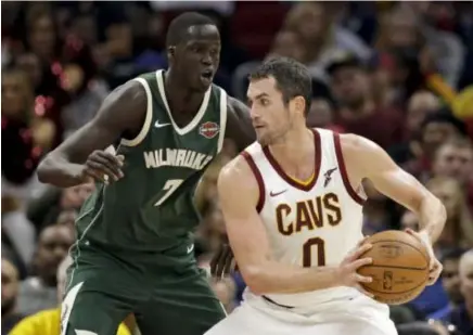  ??  ?? CLEVELAND Cavaliers’ Kevin Love (0) drives against Milwaukee Bucks’ Thon Maker (7), from Australia, in the second half of an NBA basketball game, Tuesday, Nov. 7, 2017, in Cleveland. The Cavaliers won 124-119.