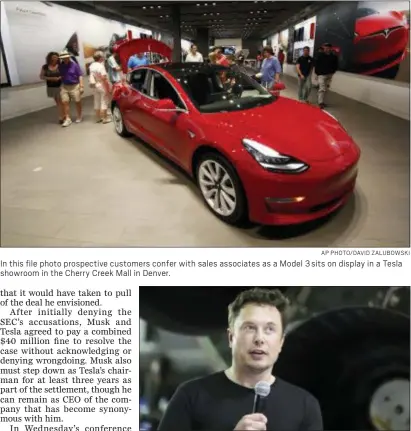  ?? AP PHOTO/DAVID ZALUBOWSKI ?? In this file photo prospectiv­e customers confer with sales associates as a Model 3 sits on display in a Tesla showroom in the Cherry Creek Mall in Denver.